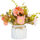 Floral arrangement in a white vase with pink and green flowers on a white background
