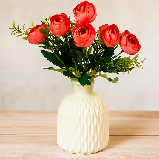 White textured vase with red roses on a wooden surface