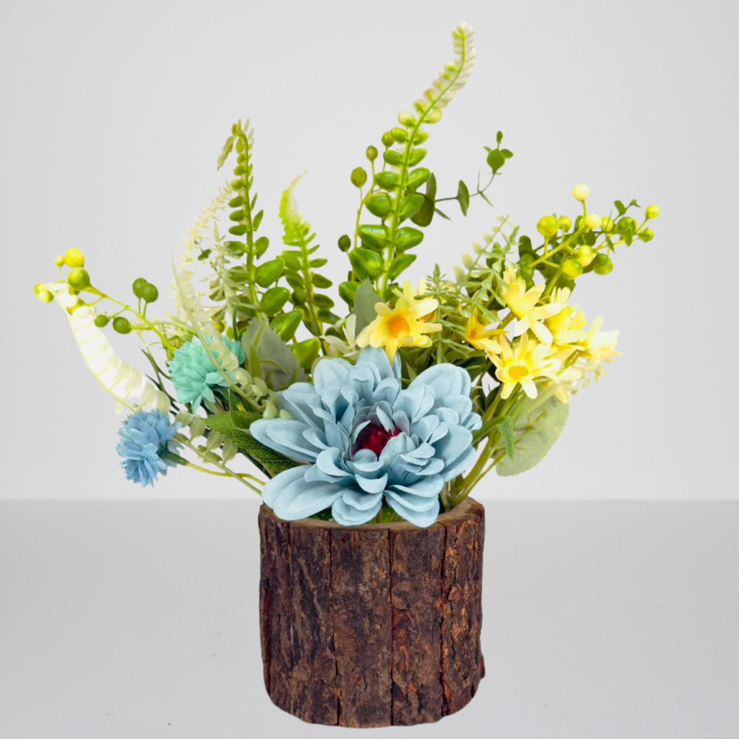 Artificial plant arrangement in a wooden pot on a light gray background