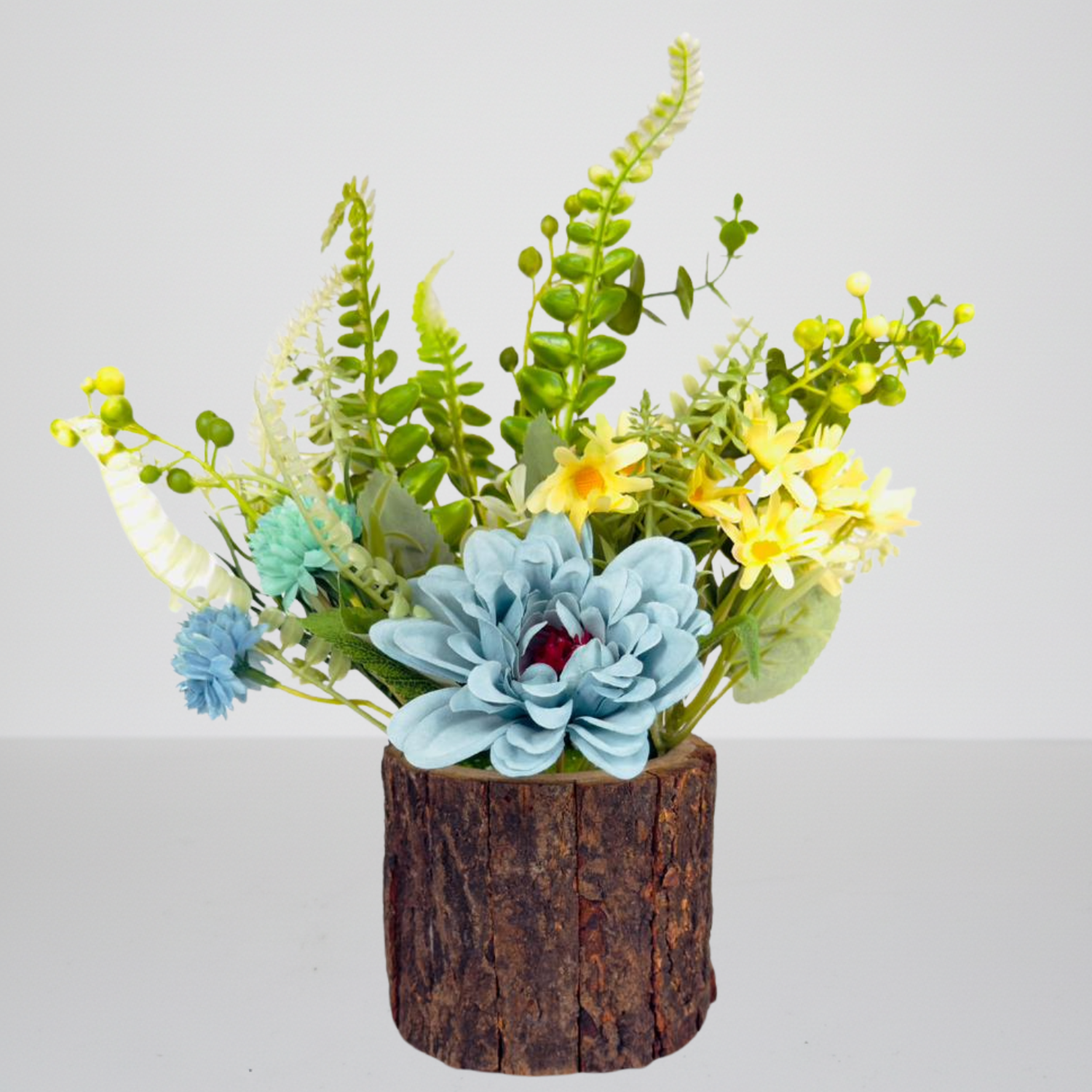 Artificial plant arrangement in a wooden pot on a light gray background