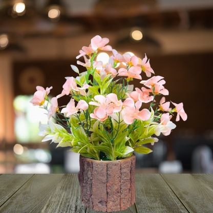 Artificial flower arrangement in a rustic pot on a wooden table with a blurred background