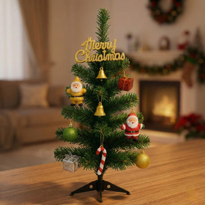Small decorated Christmas tree with ornaments on a wooden surface, blurred festive background