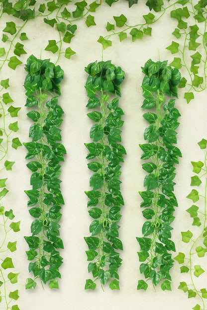 Artificial green ivy leaves on a white background